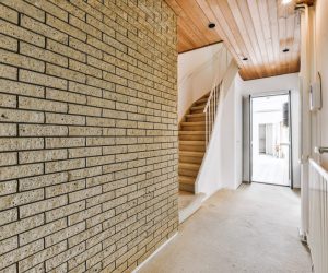 Luxury corridor with brick wall and white staircase